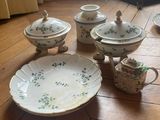 several pieces of china on a wooden floor in a living room