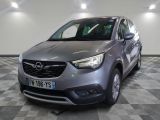 the grey opel is parked in a large room with a checkered floor