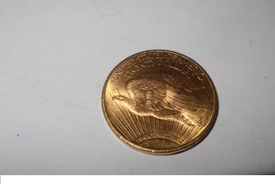 a gold coin sitting on top of a white surface