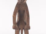 an old wooden statue of a man with a hat on his head