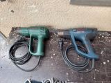two electric tools that are sitting on a table
