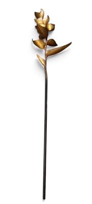 a close up of a flower on a stick on a white surface