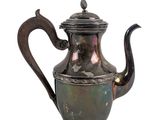 an old silver tea pot with a handle and a handle