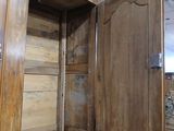 a large wooden cabinet with a mirror on it