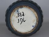 a close up of a blue vase with writing on it