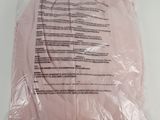 pink t - shirt in a plastic bag on a white surface