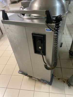 a machine that is sitting in a kitchen on the floor