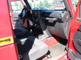 a red truck with the door open sitting in a parking lot