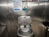 a small bathroom with a stainless steel toilet and sink