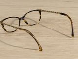a pair of glasses sitting on a wooden table