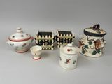 several different types of porcelain items are displayed on a table
