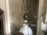 a shelf with a lamp and a mirror in the corner