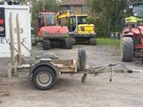 a trailer with a trailer attached to it in the dirt