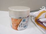 a jar of cream sitting on a counter next to a towel