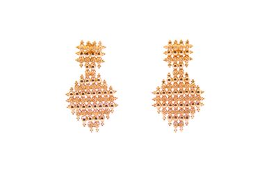 a pair of gold earrings with pink beads on a white background