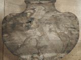 an old wooden cutting board on a wooden floor