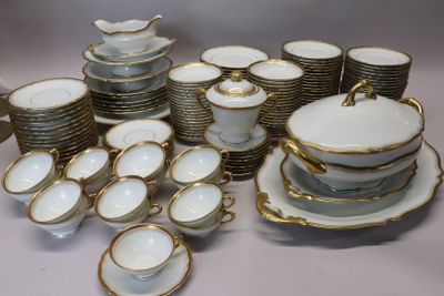 a lot of white and gold dishes and cups