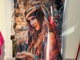 a picture of a woman that is hanging on a wall