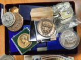 a tray of coins and other items on a table