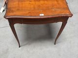 an old wooden table with a small drawer on top of it