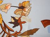 a close up of a table cloth with flowers on it
