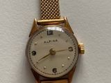 a close up of a wrist watch on a white surface