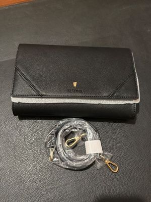 a black purse with a gold chain and a clear case