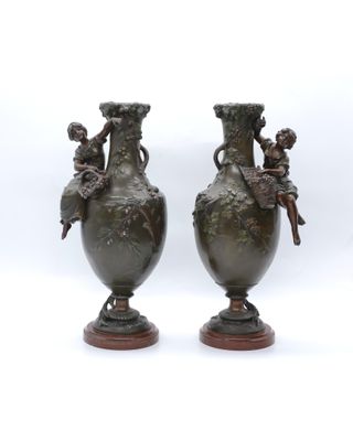 pair of antique bronze vases with cherenshes and cherenshes on them