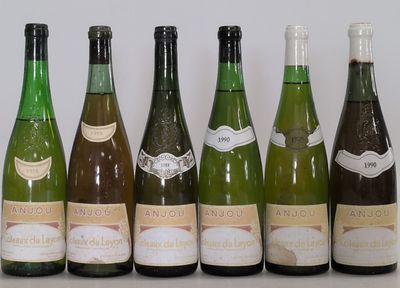 several bottles of wine are lined up on a table