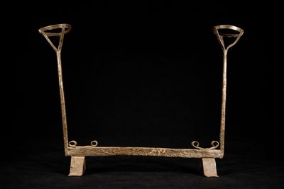 an image of a pair of metal crutts on a black background