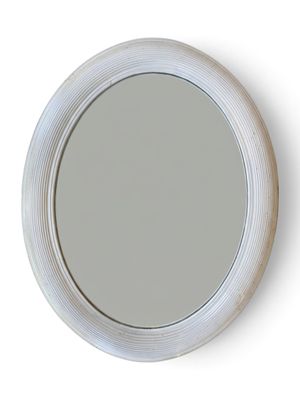 un miroir rond avec un cadre blanc accroché au mur