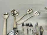 several spoons, forks, and spoons are arranged on a table