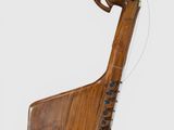 an image of a musical instrument made of wood with a wooden handle