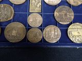 a lot of coins that are in a blue box