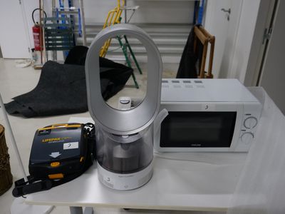 a coffee maker and a microwave sitting on a table