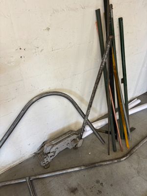 a pile of skis and poles in a garage