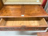 a wooden table with a drawer on top of it