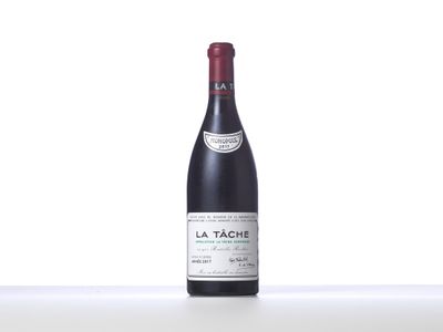 bottle of red wine sitting on top of a white table