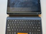 a tablet computer sitting on top of a laptop keyboard