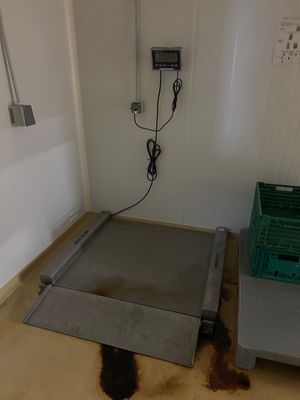 an image of a room with a scale and a trash can