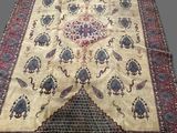an antique persian rug with a floral design on a white ground