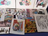 a lot of drawings that are on a blue table