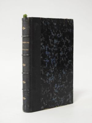 an old book sitting on top of a white table next to a white wall