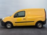 the yellow van is parked on the side of the road