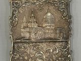an old silver plate with a picture of a building on it