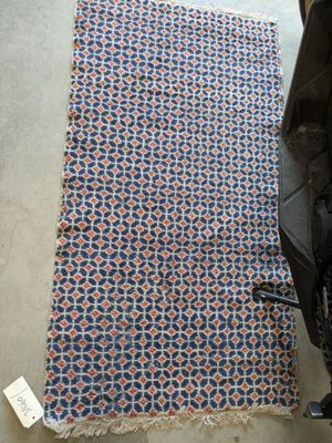 a blanket on the floor next to a stroller