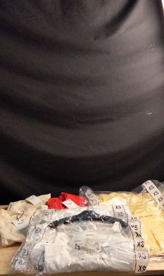 un sac de vêtements posé sur une table à côté d'une paire de ciseaux