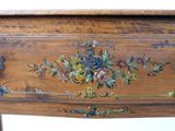 a wooden table with a floral design on it