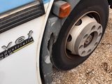 a close up of a truck tire on the ground
