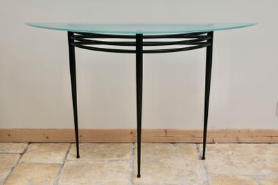 a table with a glass top on a tile floor
